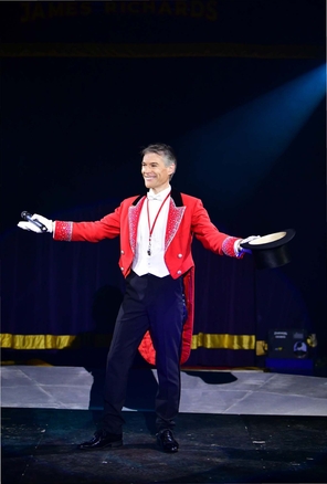 circus man hanging on ladder